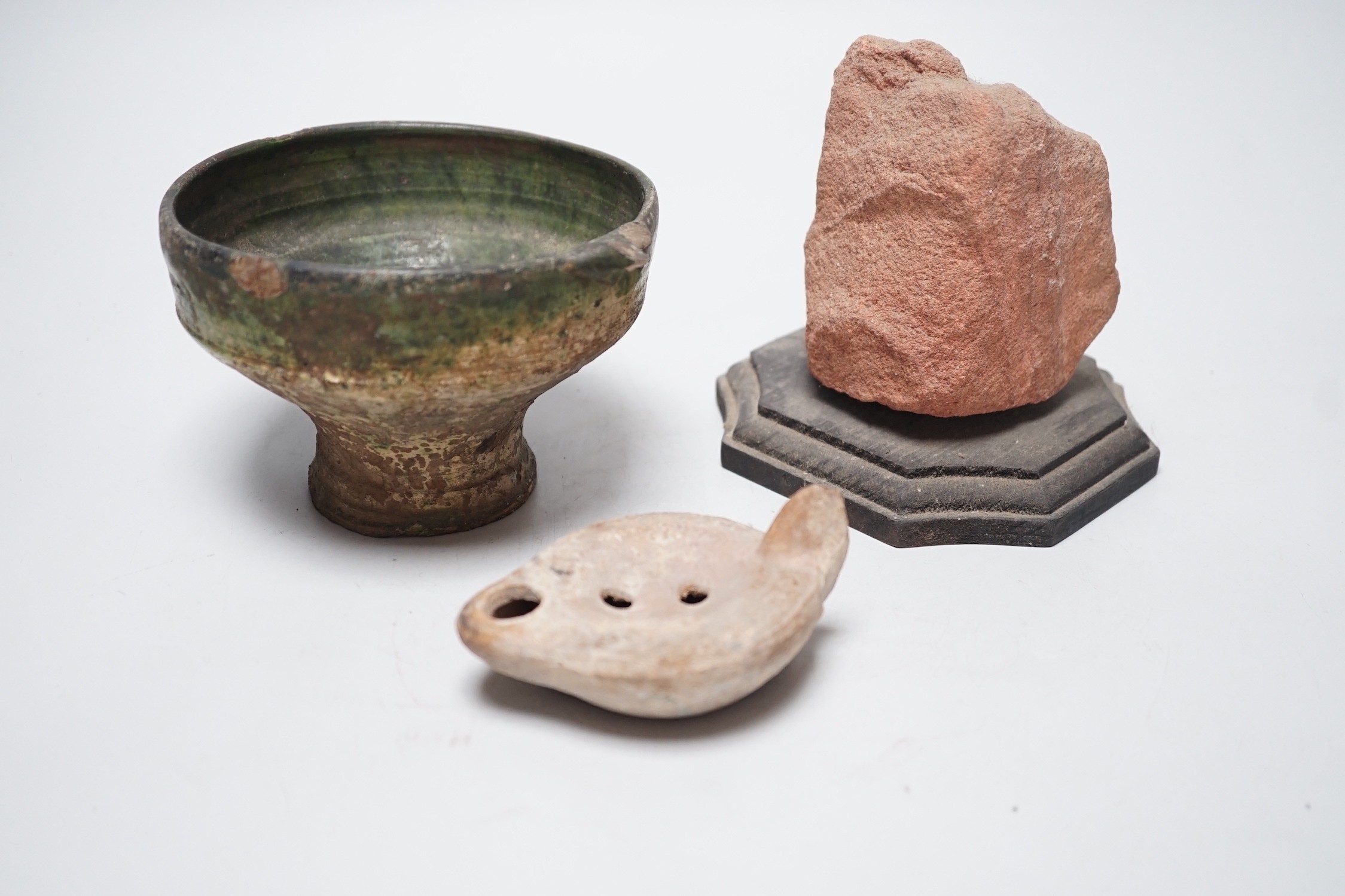 A Roman green glazed vessel, 13 cm wide and a pottery oil lamp, with letter of provenance dated 1942 stating that they were excavated 50-60 years previously during excavations for Lincoln’s Inn New chapel London and a se
